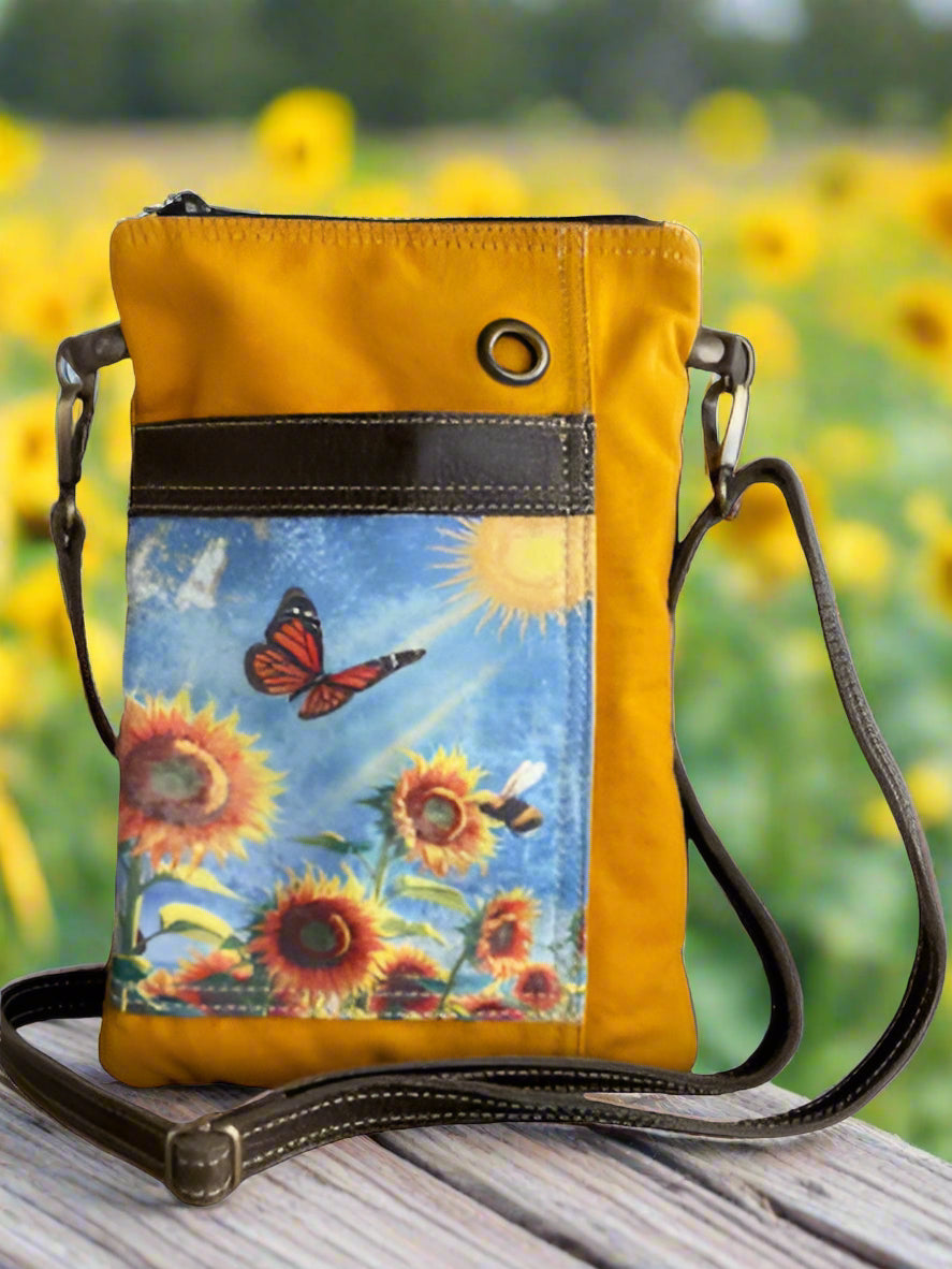 Yellow crossbody bag with sunflower and butterfly design on a white background