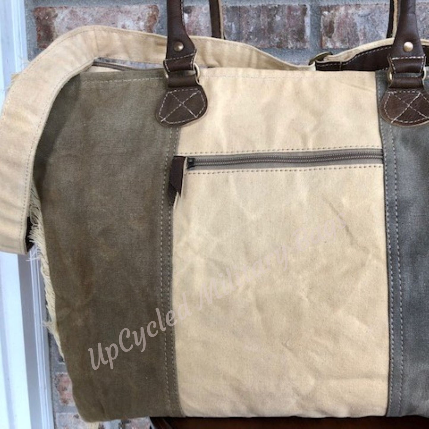 The UpCycled USA Weekender offers everything you need! Made of repurposed (recycled) military tent and tarp canvas. Tote is strong, sturdy and has both shoulder straps and a an adjustable crossbody strap. Dimensions: 17" x 14.5" x 8" (Please note Size). Features: Zip Top Closure, Shoulder Straps, Adjustable Crossbody Strap, Outside Side Pocket, Back Zip Pocket, Inside Zip Pocket, 2 Inside Pockets.