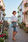 recycled military canvas bag with Two-toned bag with teal top section and gray bottom section being worn by a woman on a stroll
