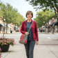 Recycled Military Canvas Gray and rust colored crossbody bag with 'Columbia's' bicycle on the large front slip pocket being worn by a woman.

