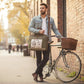 Recycled Military Canvas Messenger, satchel style bag that's geen with a vintage or retro  bicycle on the front being worn by a man standing next to a vintage bike.