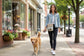 Canvas crossbody bag with 'Just Rescued' design featuring dogs walking a golden retriever dog down a small town street.