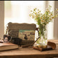 Repurposed Military Canvas wristlet with 'Longhorn' design and sunglasses on a rustic table.