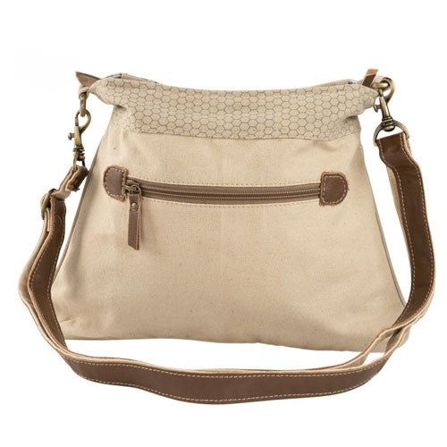an off-white crossbody bag with the image of a bee with a crown for the full queen bee effect. Multiple zip compartments for organization.