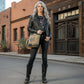 Recycled Military Canvas crossbody bag with cowboy skull design and '1899'  in an urban-western setting.