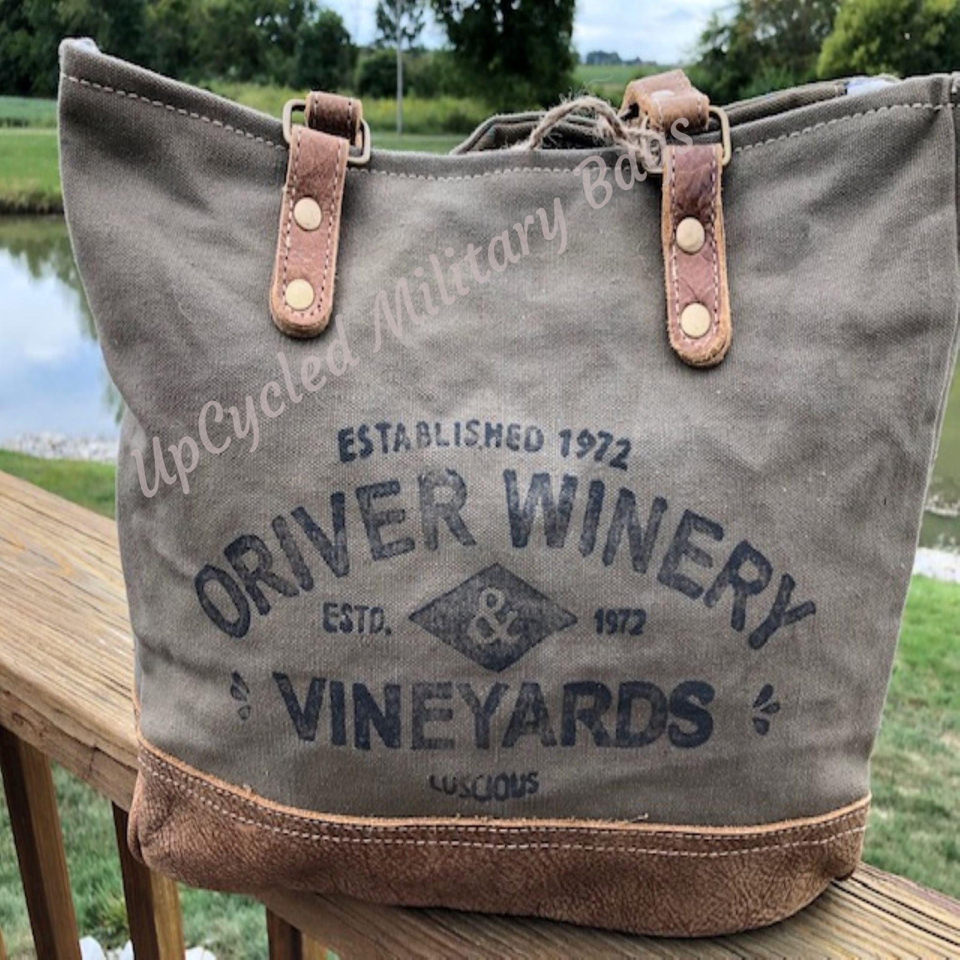 This UpCycled Oriver Winery Bag is constructed of repurposed military tent and tarp canvas. Bag Says : Oriver Winery, established 1972, Vineyards (in black distressed print). Durable enough to make every day an adventure yet still looks classy. Use as a small travel bag, everyday purse, or tote.