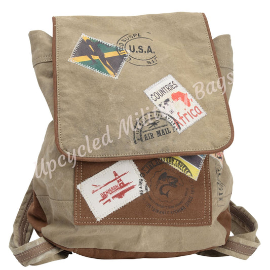 The UpCycled Travel Stamp Backpack is upcycled, crafted from re-purposed military tents, tarps and canvas. Vintage inspired with patches of travel stamps: USA, Africa, Denmark and more. Sturdy heavy canvas on this medium sized backpack. Tan with brown accents. Features include: FRONT MAGNETIC CLOSURE, ZIP TOP CLOSURE, Dimensions are 13" x 13.5" X 4", FRONT POCKET, BACK ZIPPED POCKET FULLY LINED, 1 ZIPPED INSIDE POCKET, ADJUSTABLE STRAP.