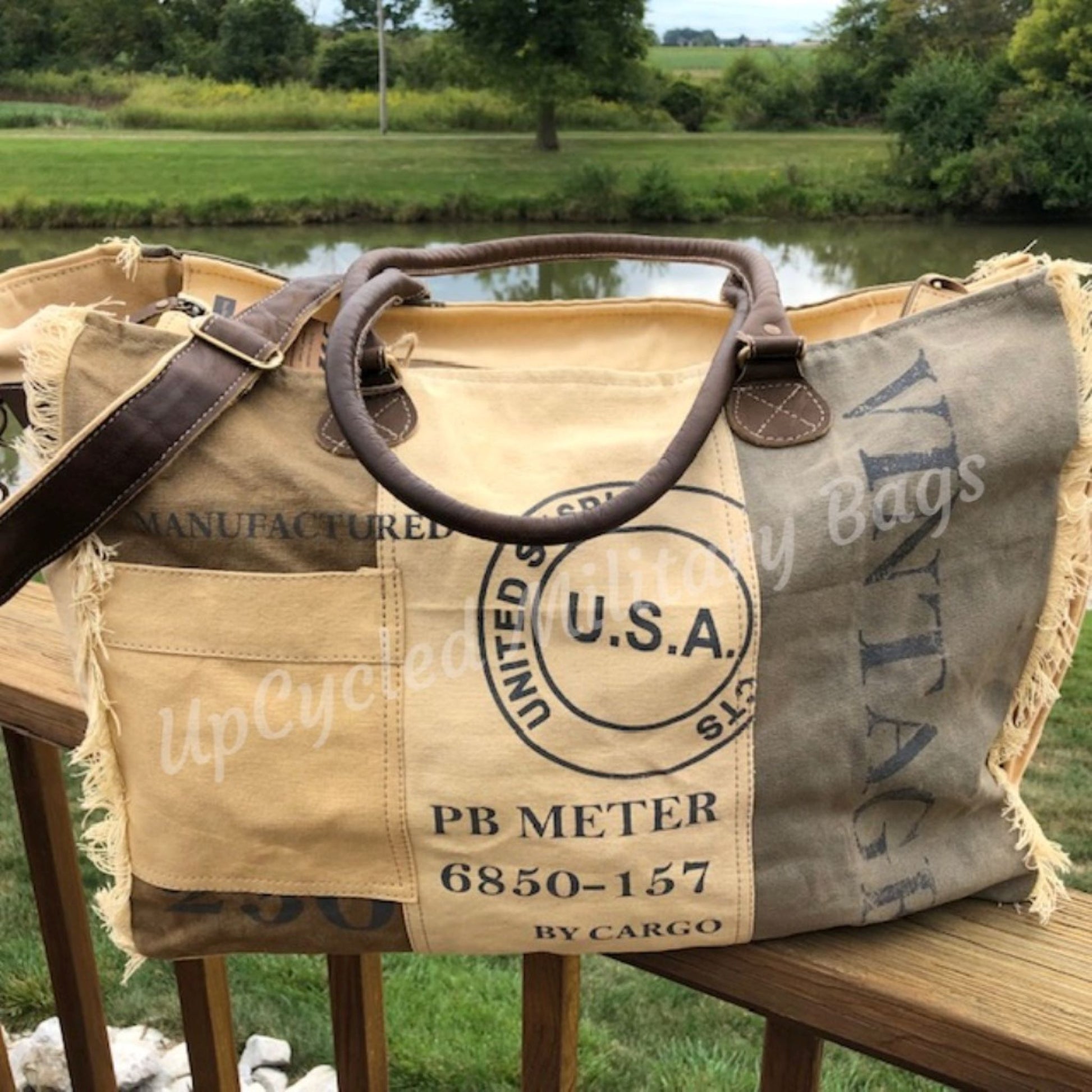 The UpCycled USA Weekender offers everything you need! Made of repurposed (recycled) military tent and tarp canvas. Tote is strong, sturdy and has both shoulder straps and a an adjustable crossbody strap. Dimensions: 17" x 14.5" x 8" (Please note Size). Features: Zip Top Closure, Shoulder Straps, Adjustable Crossbody Strap, Outside Side Pocket, Back Zip Pocket, Inside Zip Pocket, 2 Inside Pockets.